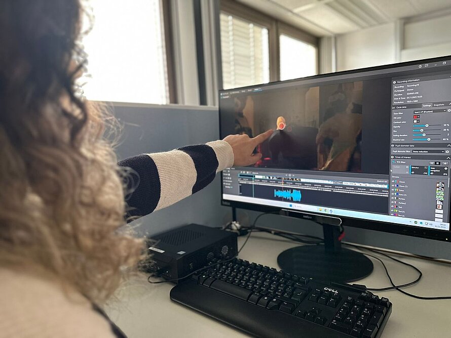 Nahaufnahme einer Person, die auf einem Monitor eine Eyetracking-Analyse einer Videoaufnahme auswertet.